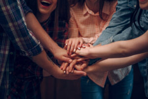 Friends putting their hands together